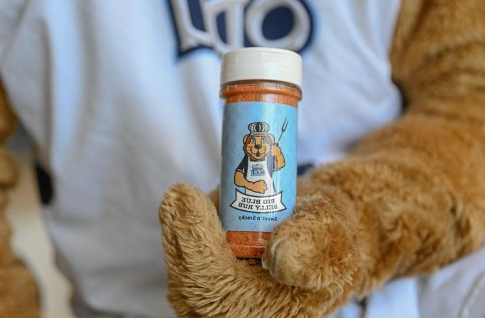 ODU’s mascot Big Blue holds a container of seasoning.